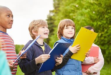 Primary school children with clipboards