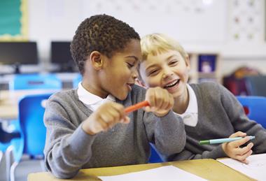 Two laughing young primary school pupils