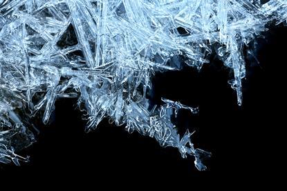 Ice crystals forming with a black background, right-hand corner