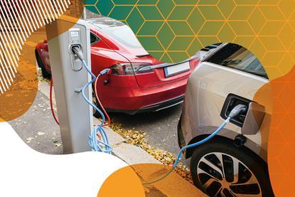 Photo of two electric cars plugged into a charging station