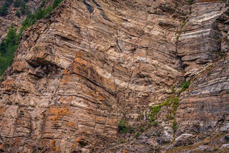 A photograph of a cliff showing layers or strata of limestone rock