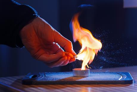 An image of juice from a piece of orange peel burning