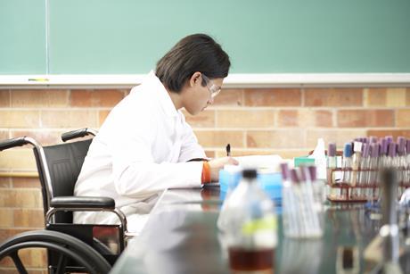 A photo of a student in a wheelchair during a practical science lesson