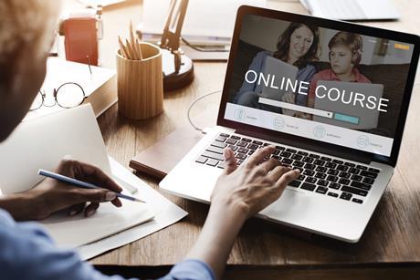 Woman signing up to online courses on her laptop