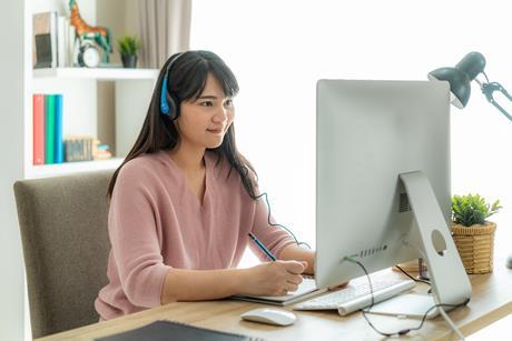 Person at a computer with headphones on