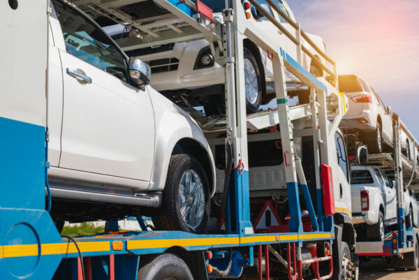 transportation of new cars on a two-level semi-trailer truck on a two-lane paved country road