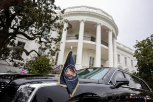 A car with flags baring the presidential seal is seen at the White House in Washington