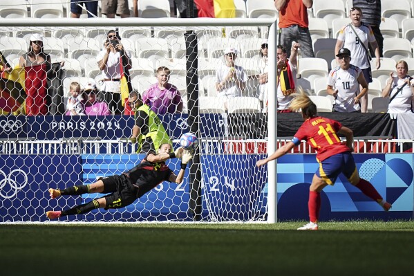 Germany's goalkeeper Ann-Katrin Berger stops a penalty by Spain's Alexia Putellas, right, during the women's bronze medal soccer match between Spain and Germany, at the Lyon stadium, during the 2024 Summer Olympics, Friday, Aug. 9, 2024, in Decines, France. (AP Photo/Laurent Cipriani)