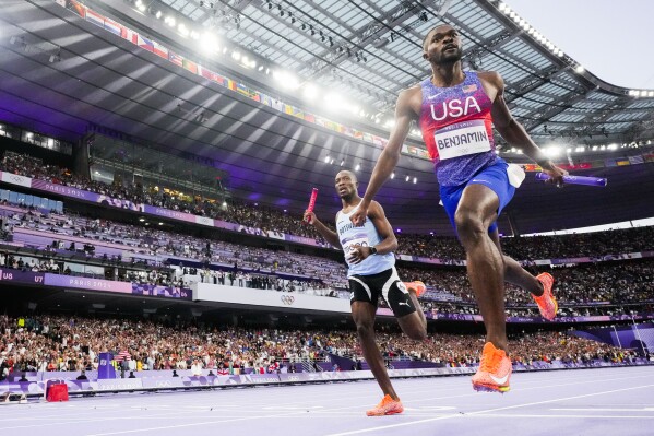 Rai Benjamin, of the United States, celebrates after winning the men's 4 x 400-meter relay final at the 2024 Summer Olympics, Saturday, Aug. 10, 2024, in Saint-Denis, France. (AP Photo/David J. Phillip)