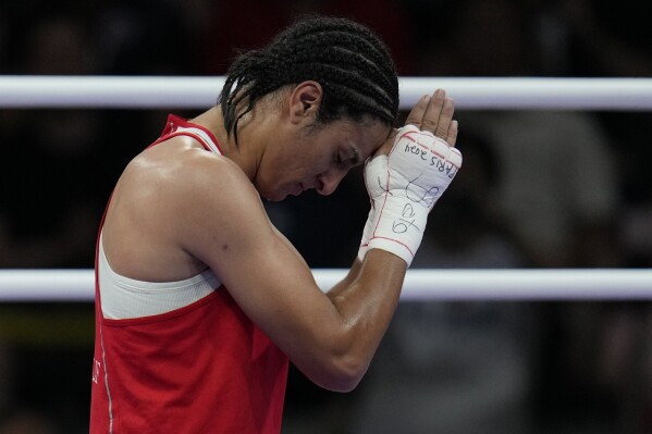 Algeria's Imane Khelif, celebrates after defeating Hungary's Anna Hamori in their women's 66kg quarterfinal boxing match at the 2024 Summer Olympics, Saturday, Aug. 3, 2024, in Paris, France. (AP Photo/John Locher)