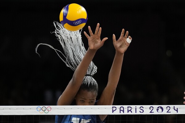 France's Amandha Sylves blocks a ball during the group A women's volleyball match between France and Serbia at the 2024 Summer Olympics, Monday, July 29, 2024, in Paris, France. (AP Photo/Alessandra Tarantino)