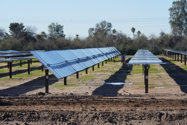 FILE - Rows of solar panels sit at Orsted's Eleven Mile Solar Center lithium-ion battery storage energy facility, Feb. 29, 2024, in Coolidge, Ariz. (AP Photo/Ross D. Franklin, File)