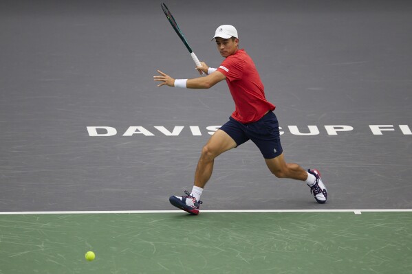 In this photo released by Xinhua News Agency, Mackenzie McDonald, of the United States plays against Lukas Klein, of Slovakia during the men's singles of the group C match between the United States and Slovakia in the Davis Cup Finals tennis tournament in Zhuhai, south China's Guangdong Province, Friday, Sept. 13, 2024. (Li Jianyi/Xinhua via AP)