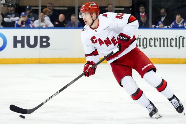 FILE - Carolina Hurricanes center Martin Necas (88) skates with the puck during Game 1 of an NHL hockey Stanley Cup second-round playoff series against the New York Rangers, May 5, 2024, in New York. The Hurricanes agreed to a two-year, $13 million deal with Necas on Monday, July 29. (AP Photo/Julia Nikhinson, File)