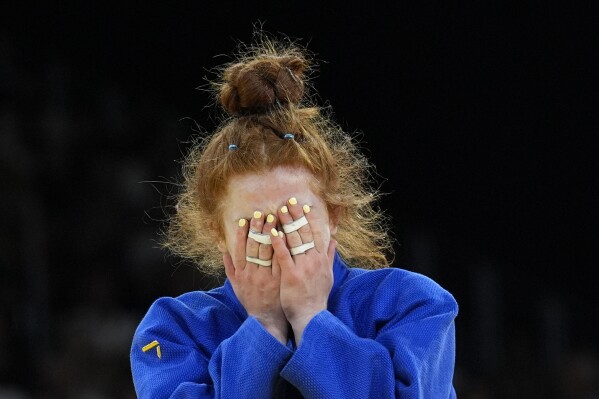 Austria's Lubjana Piovesana celebrates after defeating South Korea's Jisu Kim during their women -63 kg repechage match in team judo competition at Champ-de-Mars Arena during the 2024 Summer Olympics, Tuesday, July 30, 2024, in Paris, France. (AP Photo/Eugene Hoshiko)