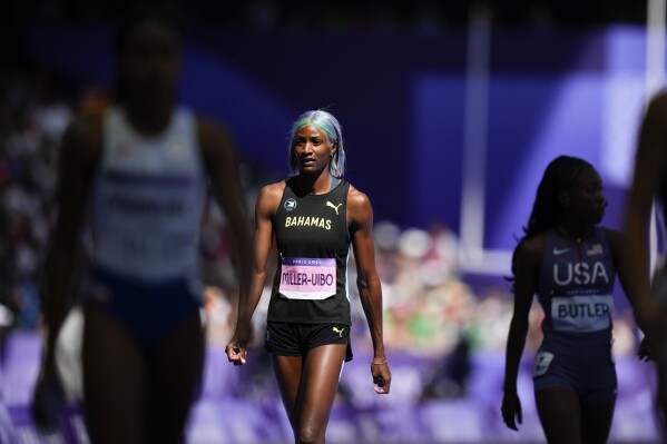 Shaunae Miller-Uibo, of Bahamas, walks down the track after failing to finish her women's 400-meters heat at the 2024 Summer Olympics, Monday, Aug. 5, 2024, in Saint-Denis, France. (AP Photo/Petr David Josek)