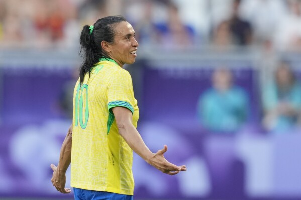 Brazil's Marta leaves the pitch after being shown a red card during a women's Group C soccer match between Brazil and Spain, at Bordeaux Stadium, during the 2024 Summer Olympics, Wednesday, July 31, 2024, in Bordeaux, France. (AP Photo/Moises Castillo)