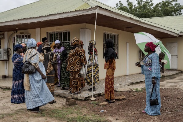 Women attend a meeting on female genital mutilation in Soma, Gambia, Thursday, July. 25, 2024. Gambia has been rocked in recent months by a heated debate on female genital cutting, a centuries-old practice rooted in concepts about sexual purity and control of women. (AP Photo/Annika Hammerschlag)