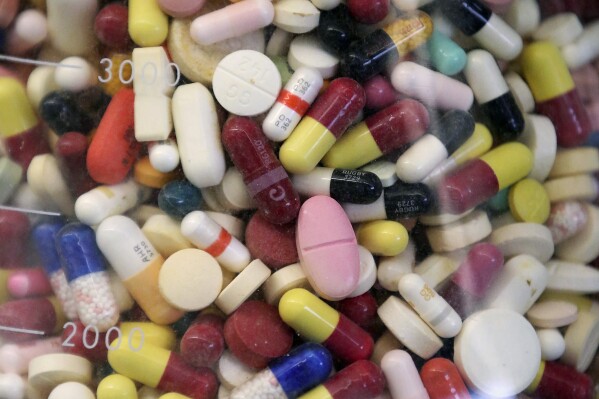 FILE - Prescription drugs are seen in a glass flask at a state laboratory in Taylorsville, Utah, on July 6, 2017. (AP Photo/Rick Bowmer, File)