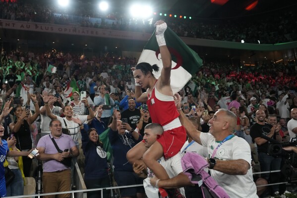 Algeria's Imane Khelif celebrates after defeating China's Yang Liu to win gold in their women's 66 kg final boxing match at the 2024 Summer Olympics, Friday, Aug. 9, 2024, in Paris, France. (AP Photo/Ariana Cubillos)