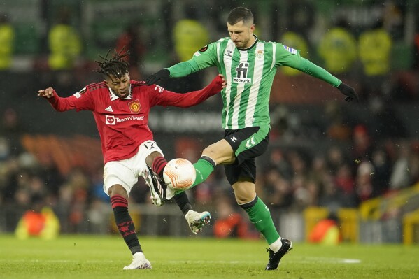 FILE - Manchester United's Fred, left, is challenged by Betis' Guido Rodriguez during the Europa League round of 16 first leg soccer match between Manchester United and Real Betis at the Old Trafford stadium in Manchester, Thursday, March 9, 2023. (AP Photo/Dave Thompson, File)