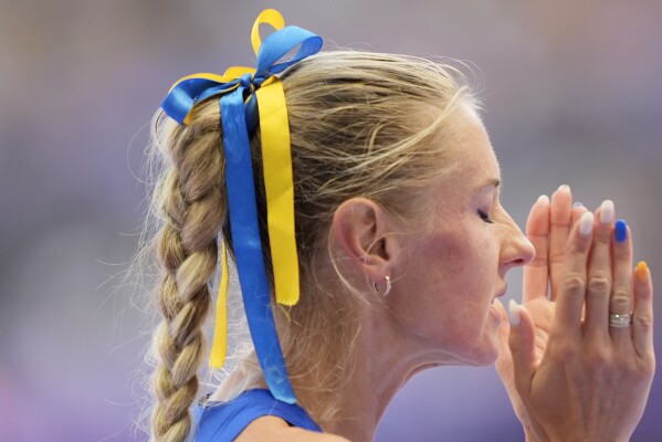 Anna Ryzhykova, of Ukraine, prepares to start in a women's 400 meters hurdles repechage round heat at the 2024 Summer Olympics, Monday, Aug. 5, 2024, in Saint-Denis, France. (AP Photo/Martin Meissner)