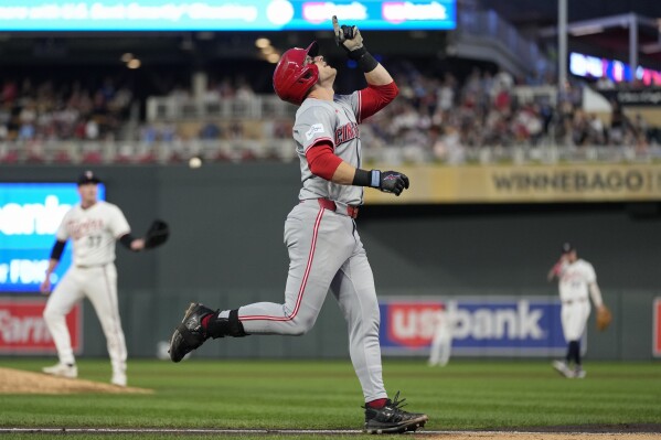 Cincinnati Reds' TJ Friedl points while running the bases after hitting a 2-run home run during the fourth inning of a baseball game against the Minnesota Twins, Saturday, Sept. 14, 2024, in Minneapolis. (AP Photo/Abbie Parr)