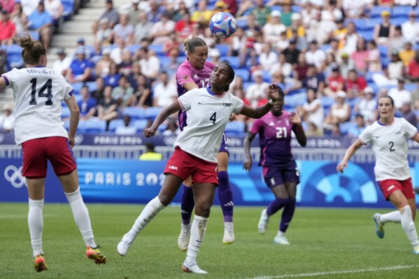 Germany's Klara Buehl fights for the ball with United States' Naomi Girma during a women's semifinal soccer match between the United States and Germany at the 2024 Summer Olympics, Tuesday, Aug. 6, 2024, at Lyon Stadium in Decines, France. (AP Photo/Silvia Izquierdo)