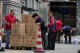 Workers load and pack gift boxes for the upcoming Mid-Autumn Festival, outside a supermarket in Beijing on Sept. 11, 2024. (AP Photo/Andy Wong)