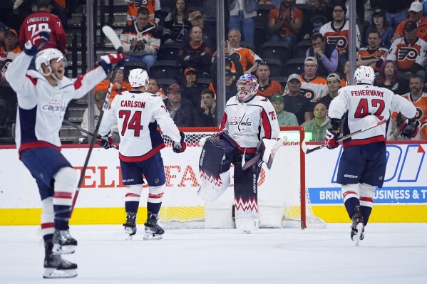 FILE - Washington Capitals' Charlie Lindgren (79) celebrates with Martin Fehervary (42) and John Carlson (74) after the Capitals won an NHL hockey game against the Philadelphia Flyers, Tuesday, April 16, 2024, in Philadelphia. So much for just trying to get Alex Ovechkin to break Wayne Gretzky’s NHL career goals record. The Washington Capitals are going all in to keep their contending window open. (AP Photo/Matt Slocum, File)