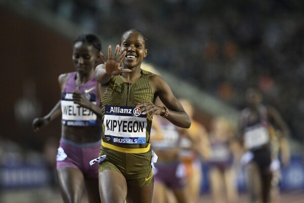 Faith Kipyegon, of Kenya, celebrates after crossing the finish line to win the women's 1500 meters during the Diamond League final 2024 athletics meet in Brussels, Saturday, Sept. 14, 2024. (AP Photo/Frederic Sierakowski)