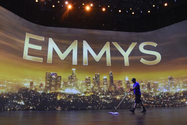 FILE - A crew member sweeps the stage during Press Preview Day for the 71st Primetime Emmy Awards in Los Angeles on Sept. 19, 2019. (Photo by Chris Pizzello/Invision/AP, File)