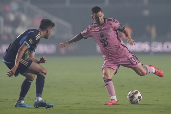 Inter Miami forward Lionel Messi (10) kicks the ball away from Philadelphia Union midfielder Leon Flach (31) during the first half of an MLS soccer match, Saturday, Sept. 14, 2024, in Fort Lauderdale, Fla. (AP Photo/Marta Lavandier)