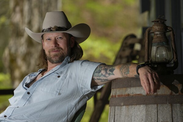 Brian Kelley poses for a portrait outside his cabin Wednesday, April 17, 2024, in Nashville, Tenn. (AP Photo/George Walker IV)