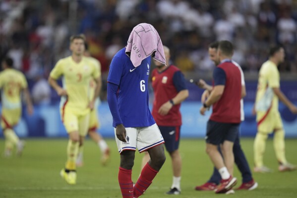 France's Manu Kone reacts after losing the men's soccer gold medal match against Spain at the Parc des Princes during the 2024 Summer Olympics, Friday, Aug. 9, 2024, in Paris, France. (AP Photo/Francisco Seco)