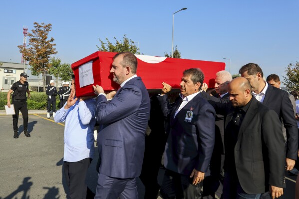 Turkish authorities carry the coffin of Turkish-American activist Aysenur Ezgi Eygi during a ceremony at Istanbul airport, in Istanbul, Turkey, Friday, Sept. 13, 2024. (IHA via AP)