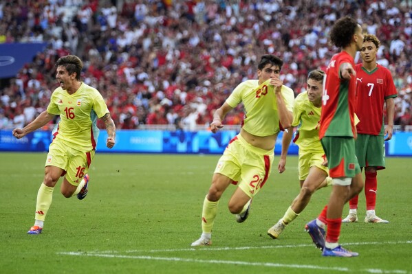 Spain's Juanlu Sanchez celebrates scoring his side's second goal during a men's semifinal soccer match between Morocco and Spain at the 2024 Summer Olympics, Monday, Aug. 5, 2024, at Marseille Stadium in Marseille, France. (AP Photo/Julio Cortez)