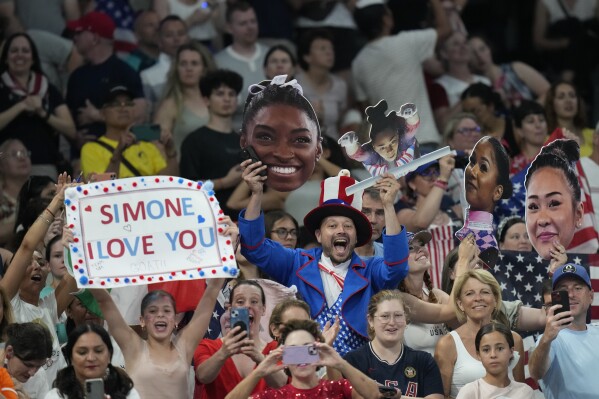 Fans cheer during the women's artistic gymnastics team finals round at Bercy Arena at the 2024 Summer Olympics, Tuesday, July 30, 2024, in Paris, France. (AP Photo/Natacha Pisarenko)