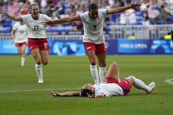 United States' Sophia Smith celebrates with team mates the opening goal during a women's semifinal soccer match between the United States and Germany at the 2024 Summer Olympics, Tuesday, Aug. 6, 2024, at Lyon Stadium in Decines, France. (AP Photo/Silvia Izquierdo)