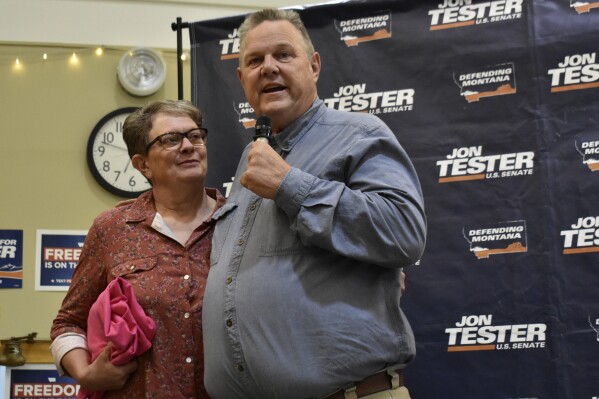 U.S. Sen. Jon Tester, D-Mont., speaks while standing next to his wife, Sharla, at a campaign rally, Thursday, Sept. 5, 2024, in Bozeman, Mont. (AP Photo/Matthew Brown)