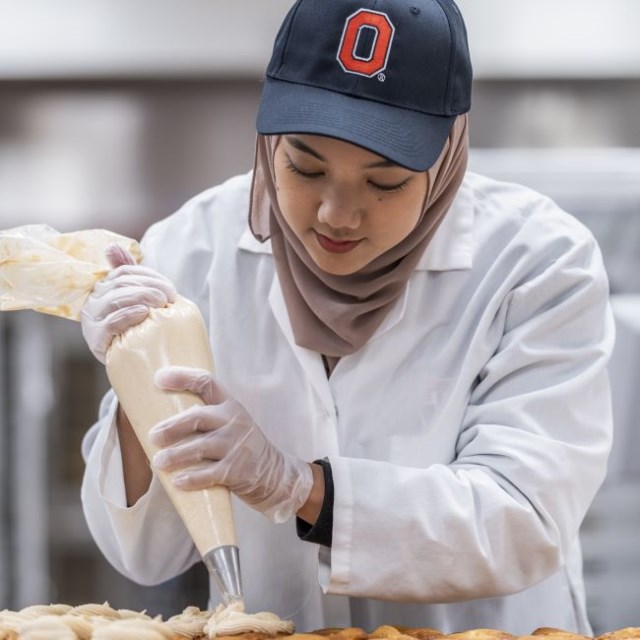 Ohio State student icing cookies