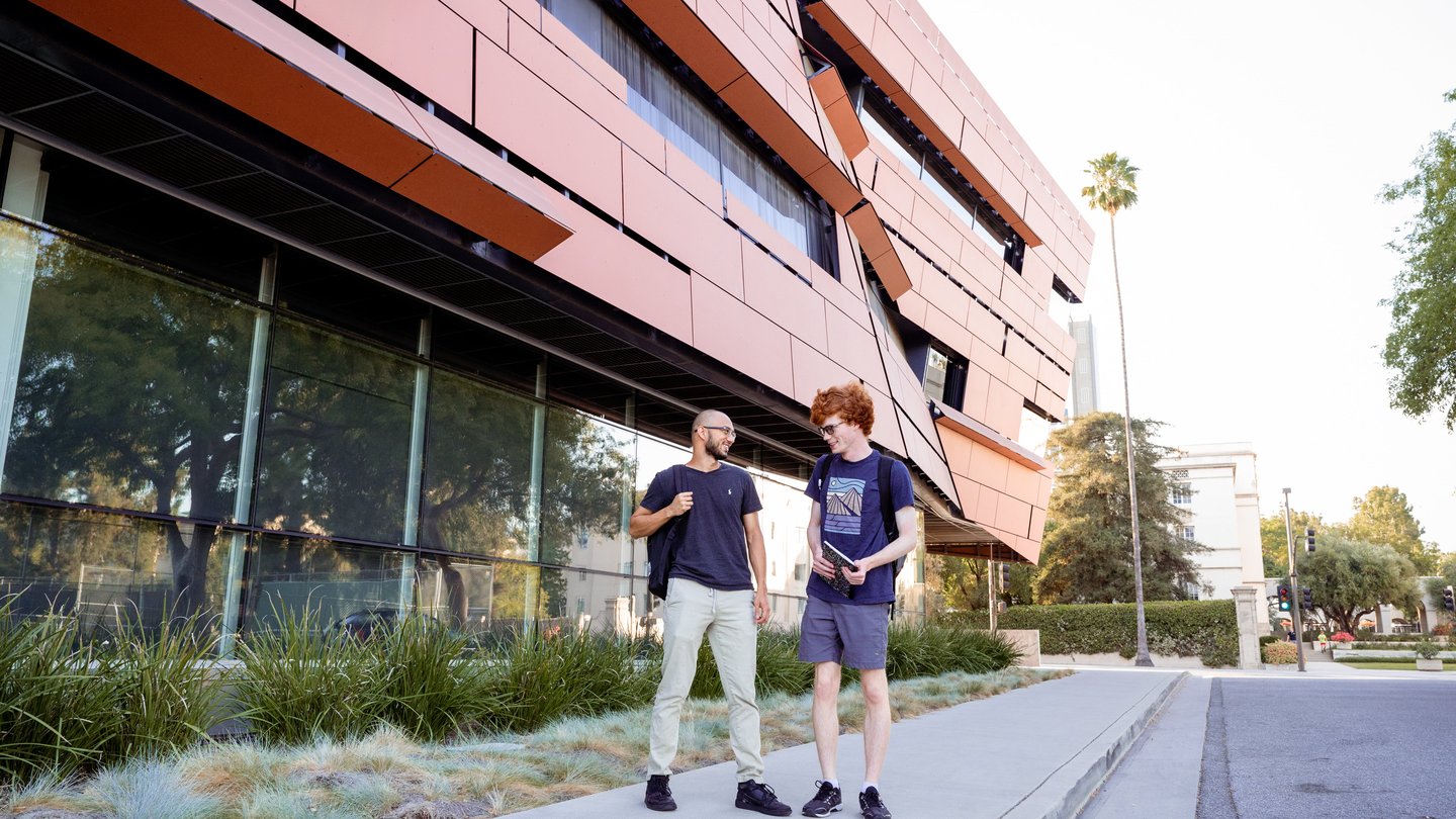 two students talking to each other on campus