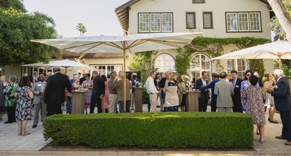 Group of people outside the front of a house