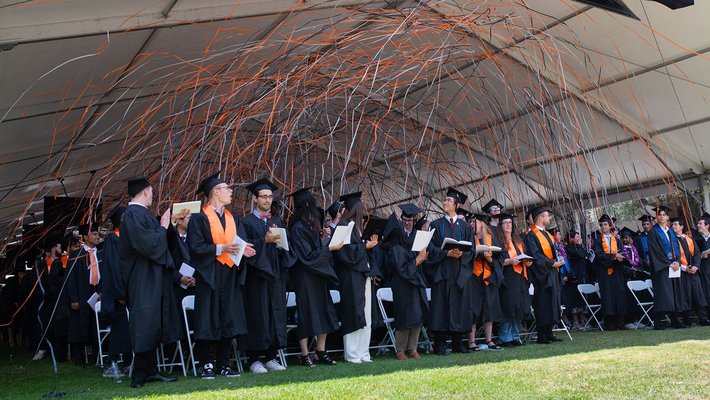 Confetti falls on the graduating class of 2024 at Commencement