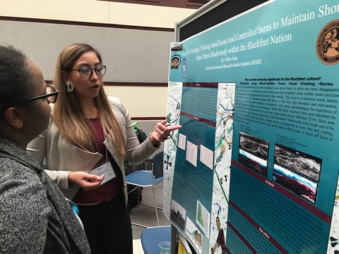 REU student presenting at a poster session