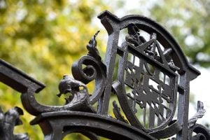 Hopkins shield, in iron, above an iron gate.