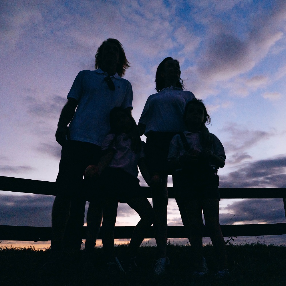 Image of silhouettes of a group of four children of different ages