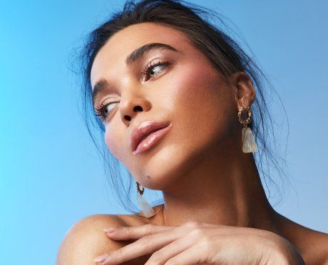 Female model looking left with a sky backdrop