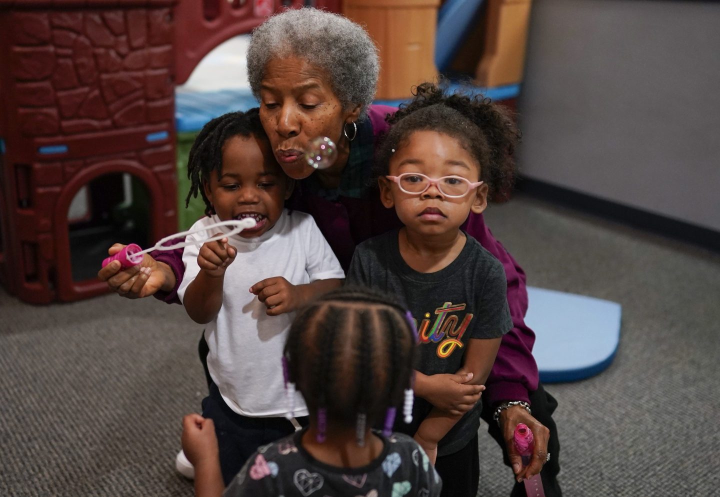 Toddler teacher Janice Bradley blows bubbles with a toddler group at the Life Learning Center &#8211; Head Start, in Cincinnati, Tuesday, Nov. 21, 2023. A new plan from the Biden administration could significantly increase salaries for hundreds of low-paid early childhood teachers caring for the country&#8217;s poorest children but might also force some centers to cut enrollment. (AP Photo/Carolyn Kaster)