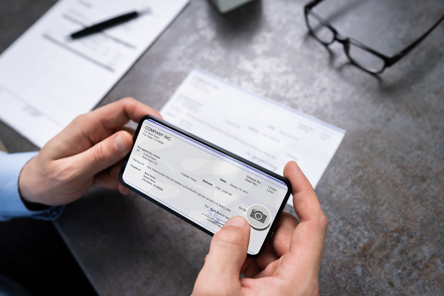 Man Taking Photo Of Check To Make Remote Deposit